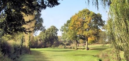 18 Holes of Golf with Bacon Roll and Coffee for Two or Four at Windmill Village Golf and Leisure Club (49% Off)